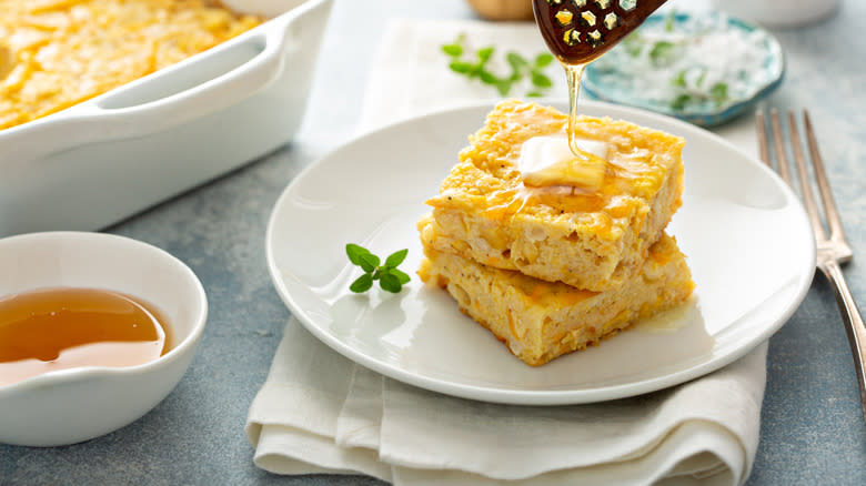 cheesy cornbread slices stacked on plate