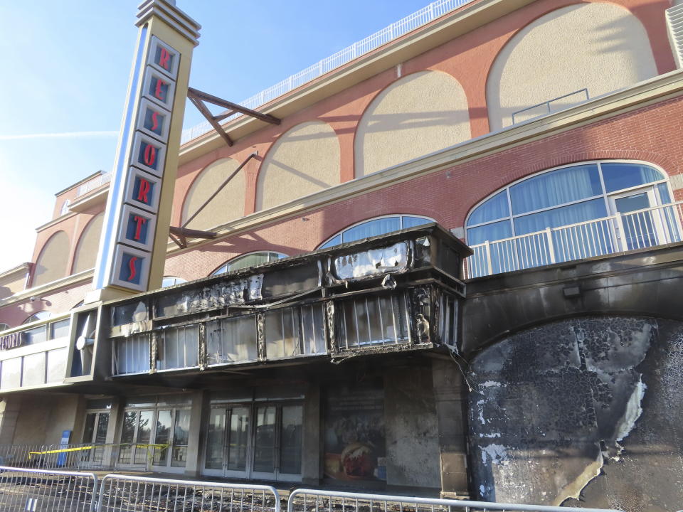 Scaffolding blocks off part of the Atlantic City, N.J. Boardwalk on Nov. 16, 2023, a day after a fire damaged part of the walkway and part of the facade of Resorts casino, which remained open. (AP Photo/Wayne Parry)