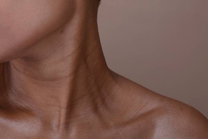 Close-up of a person's neck and shoulder with visible skin texture and details. No text or additional elements present