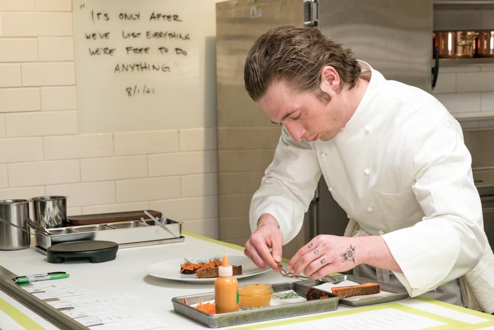 Carmy plating food in the kitchen