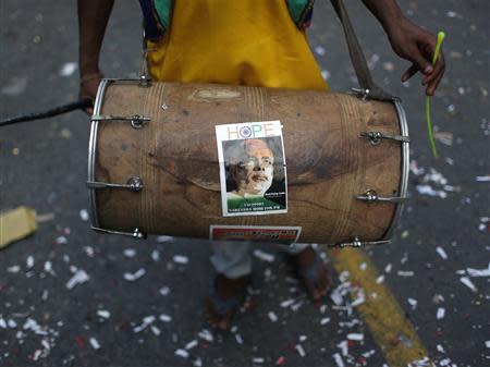 An image of India's Hindu nationalist Narendra Modi is pasted on a drum during celebrations before Modi was crowned as the prime ministerial candidate for India's main opposition Bharatiya Janata Party (BJP), outside its party headquarters in New Delhi September 13, 2013. REUTERS/Ahmad Masood