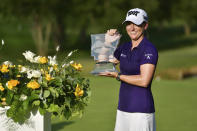 Austin Ernst holds the championship trophy after winning the LPGA Walmart NW Arkansas Championship golf tournament, Sunday, Aug. 30, 2020, in Rogers, Ark. (AP Photo/Michael Woods)