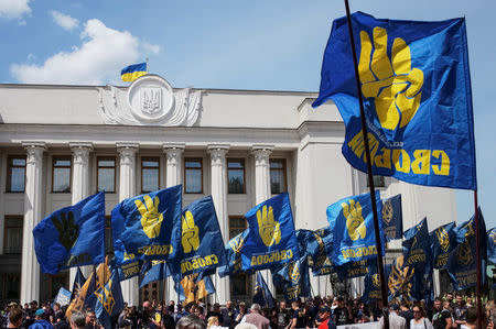 Activists of far-right parties attend a rally to demand lawmakers vote to change election law, in front of the parliament building in Kiev, Ukraine May 22, 2019. REUTERS/Gleb Garanich