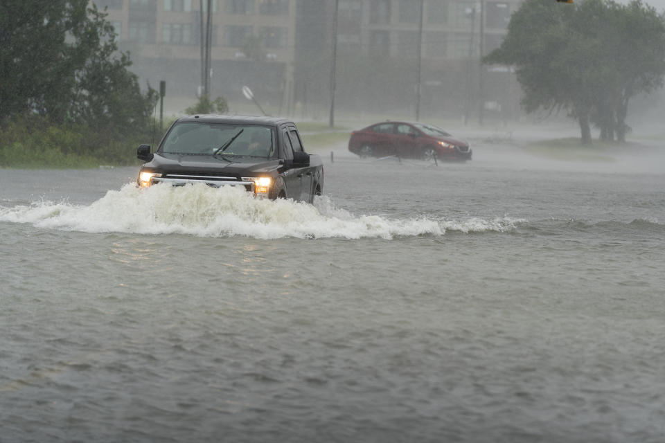 A motorist drives though high water in Charleston, South Carolina, as another turns around, on Sept. 30, 2022. / Credit: Alex Brandon / AP