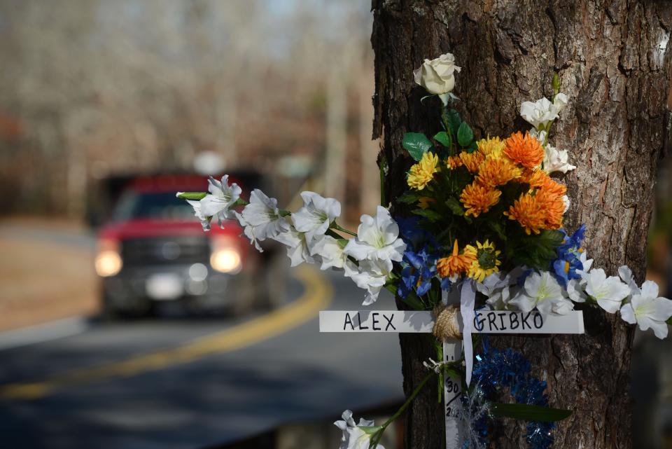 A memorial on a tree for Alexander Gribko Jr. on a sharp bend in Winslow Gray Road in West Yarmouth near where he was struck and killed by a hit and run driver in November while walking. He was one of seven pedestrians who died in 2021 on the Cape.