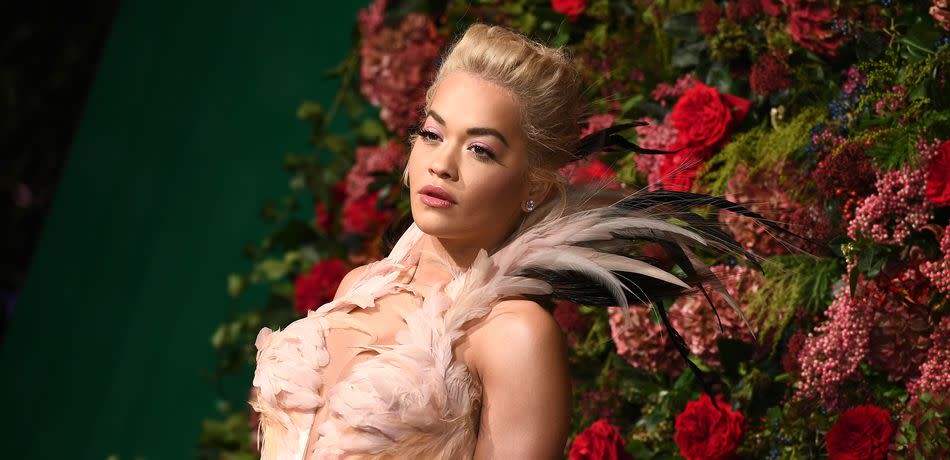 Rita Ora wears an elaborate pink dress with fringes.