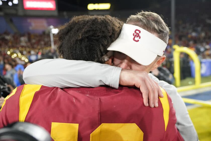 Southern California quarterback Caleb Williams, left, gets a hug from head coach Lincoln Riley after USC defeated UCLA 48-45 in an NCAA college football game Saturday, Nov. 19, 2022, in Pasadena, Calif. (AP Photo/Mark J. Terrill)