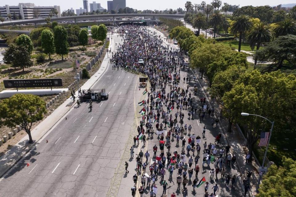 In this photo taken by a drone, thousands of demonstrators protest outside the Federal Building against Israel and in support of Palestinians during the current conflict in the Middle East, Saturday, May 15, 2021, in the Westwood section of Los Angeles. (AP Photo/Ringo H.W. Chiu)