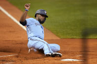 Toronto Blue Jays' Teoscar Hernandez slides into home plate to score on a single by Cavan Biggio during the first inning of the team's baseball game against the Boston Red Sox at Fenway Park, Thursday, July 29, 2021, in Boston. (AP Photo/Elise Amendola)