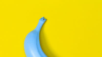 blue banana on yellow background