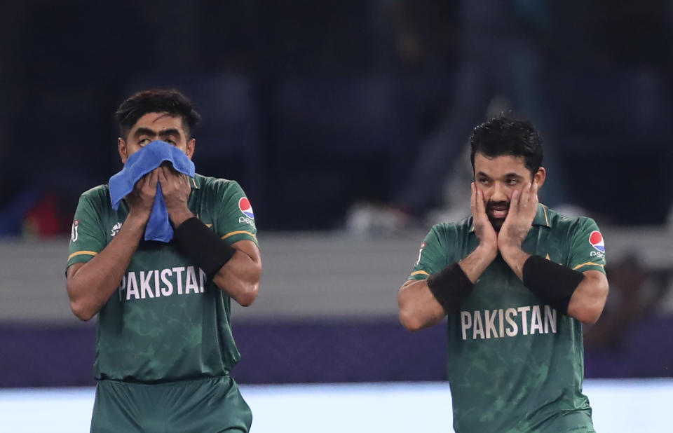 Pakistan's cricket captain Babar Azam, left, and Mohammad Rizwan leave the pitch after their team won the Cricket Twenty20 World Cup match between India and Pakistan in Dubai, UAE, Sunday, Oct. 24, 2021. (AP Photo/Aijaz Rahi)