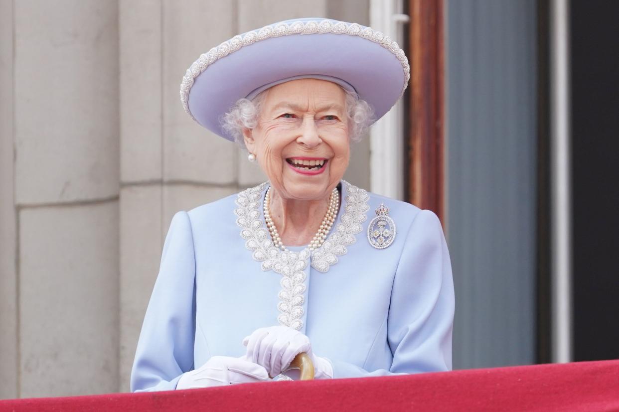 Queen Elizabeth II watches from the balcony of Buckingham Palace during the Trooping the Colour parade on June 2, 2022, in London, England.