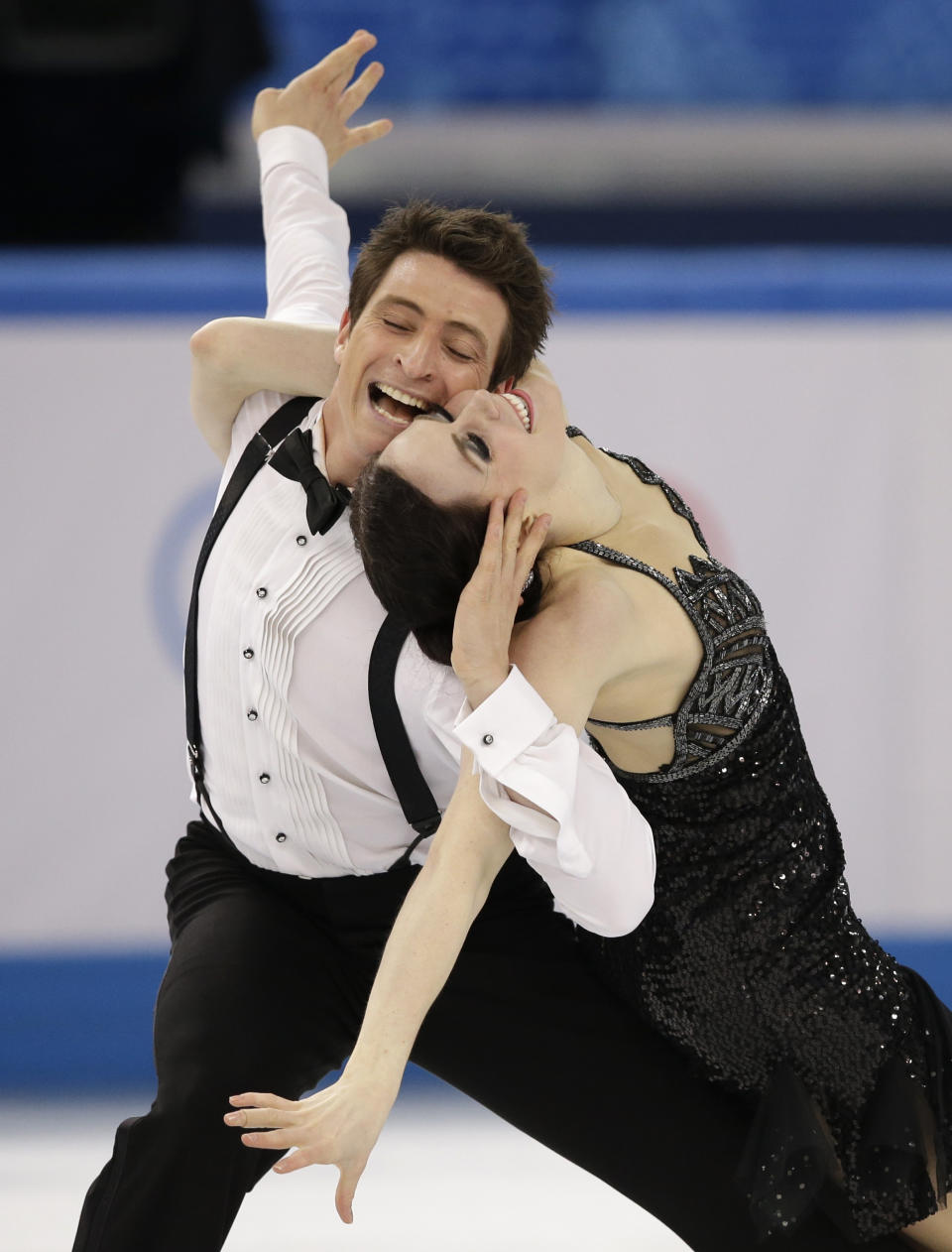 Tessa Virtue and Scott Moir of Canada compete in the ice dance short dance figure skating competition at the Iceberg Skating Palace during the 2014 Winter Olympics, Sunday, Feb. 16, 2014, in Sochi, Russia. (AP Photo/Darron Cummings)