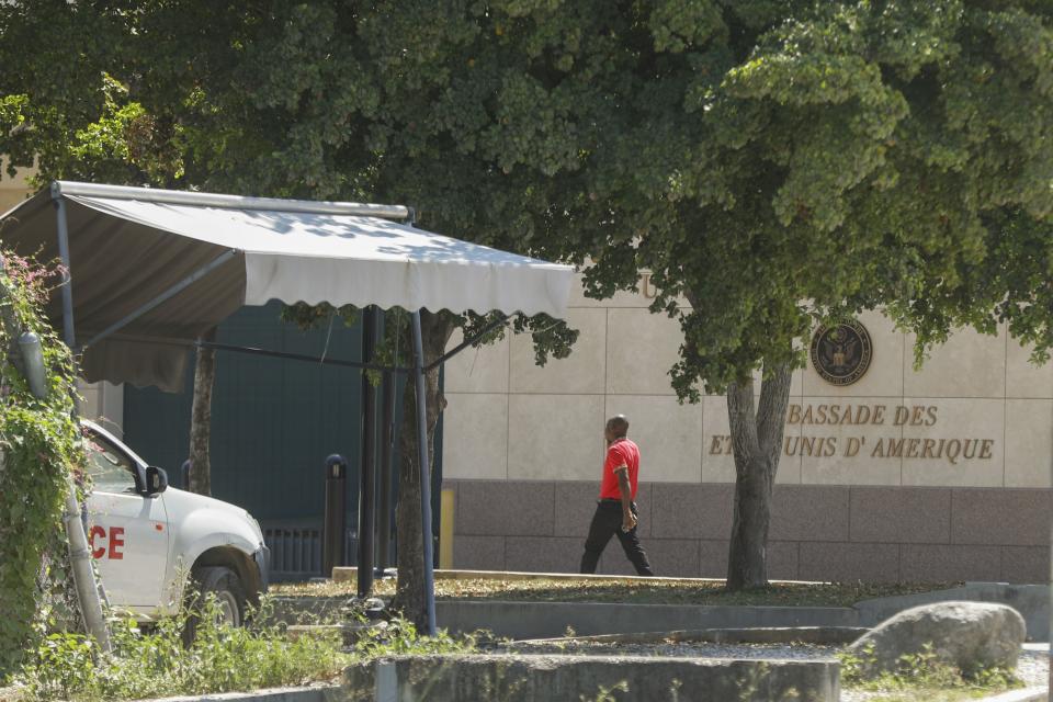 A man enters the U.S. embassy in Port-au-Prince, Haiti, Sunday, March 10, 2024. The U.S. military said Sunday that it had flown in forces to bolster security at the delegation and facilitate the departure of nonessential personnel. (AP Photo/Odelyn Joseph)