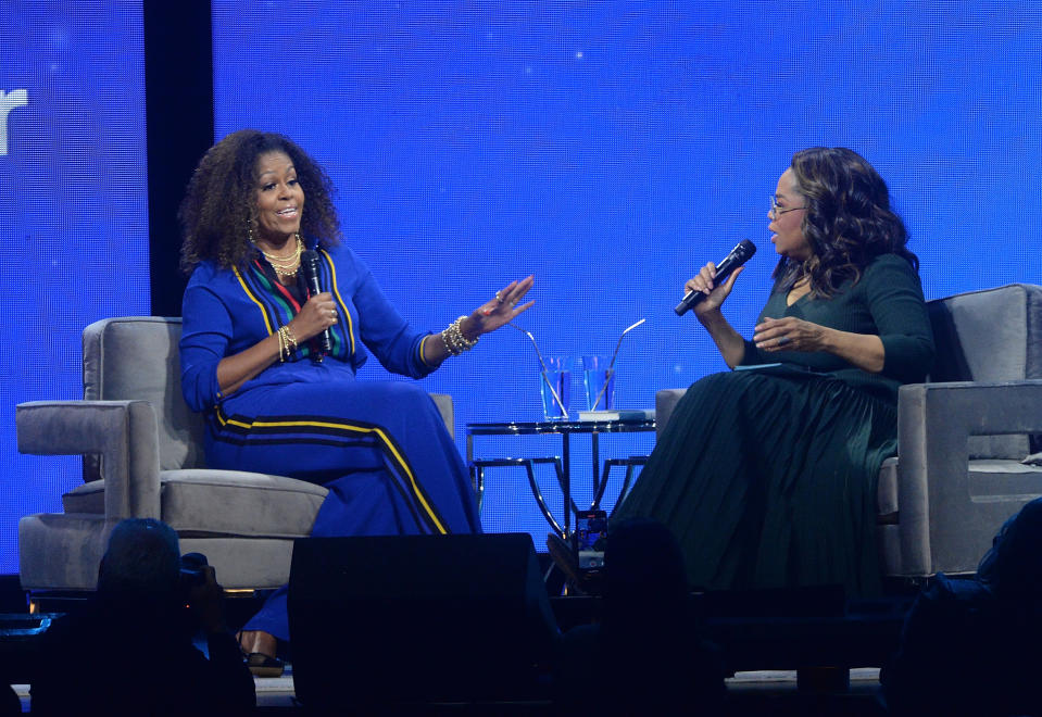 Michelle Obama, left, and Oprah Winfrey speak onstage at "Oprah's 2020 Vision: Your Life in Focus" tour at the Barclays Center on Saturday, Feb. 8, 2020, in New York. (Photo by Brad Barket/Invision/AP)