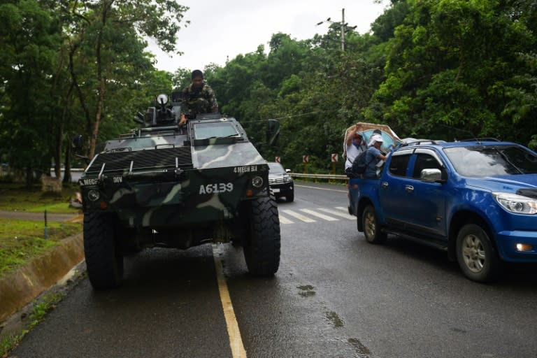 Thousands of residents have fled Marawi, gathering their belongings and heading onto a highway where Armoured Personnel Carriers (APCs) also patrolled