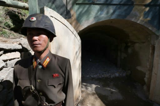 A North Korean soldier stands at the entrance to a tunnel at the Punggye-ri nuclear test facility prior to its demolition