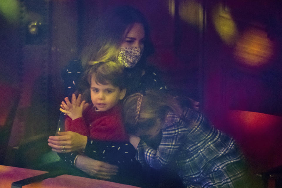 Catherine, Duchess of Cambridge, Prince Louis and Princess Charlotte attend a special pantomime performance at London's Palladium Theatre, hosted by The National Lottery, to thank key workers and their families for their efforts throughout the pandemic on December 11, 2020 in London, England. (Photo by  Aaron Chown - WPA Pool/Getty Images)