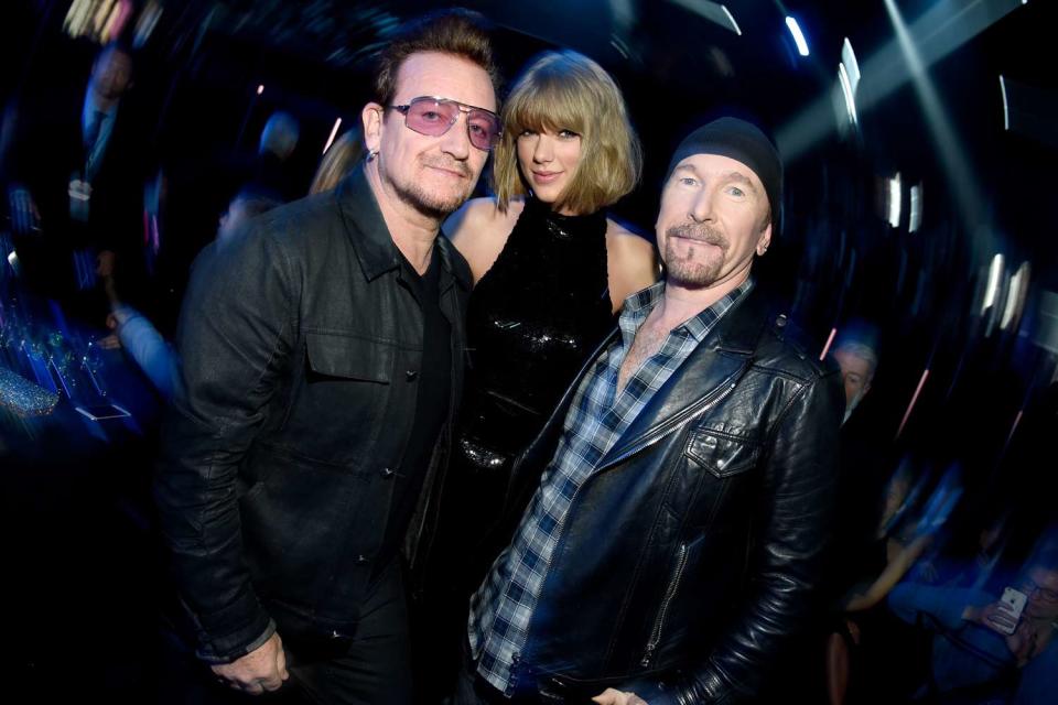 <p>Kevin Mazur/Getty</p> (L-R) Bono of U2, Taylor Swift, and The Edge of U2 backstage at the iHeartRadio Music Awards in Los Angeles in April 2016