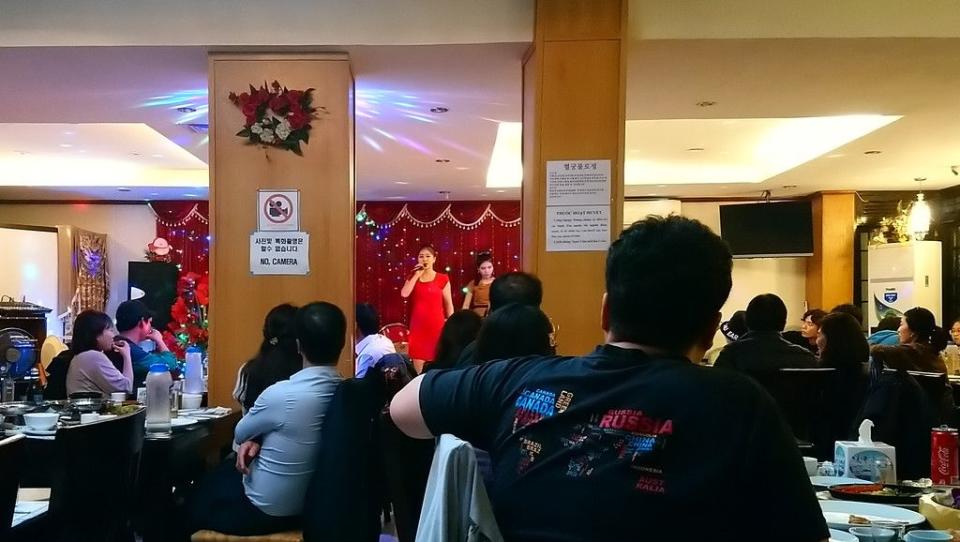 A waitress and performer sings at a North Korea state-owned Pyongyang restaurant in Hanoi, Vietnam, part of a chain of 125 similar eating places owned by the nation.
