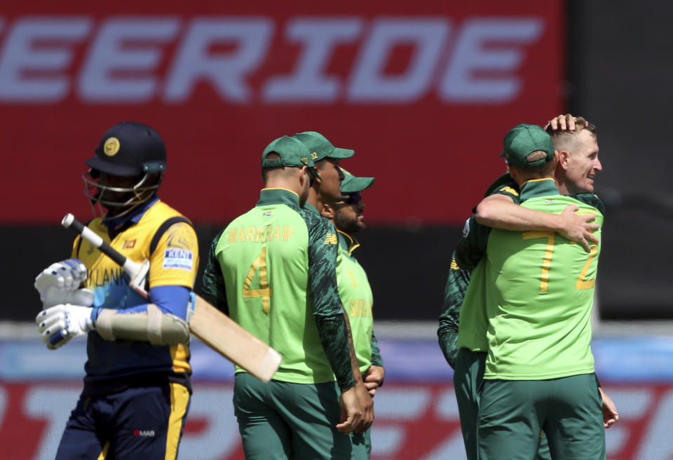 South Africa's bowler Chris Morris, far right, celebrates with teammates after bowling Sri Lanka's batsman Angelo Mathews, far left, for 30 runs during the Cricket World Cup match between Sri Lanka and South Africa at the Riverside Ground in Chester-le-Street, England, Friday, June 28, 2019. (AP Photo/Scott Heppell)