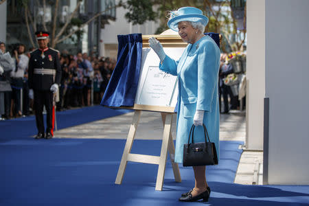 Britain's Queen Elizabeth unveils a plaque to commemorate her visit to the headquarters of British Airways, as British Airways mark their centenary year, in Heathrow, west London, Britain May 23, 2019. Tolga Akmen/Pool via REUTERS