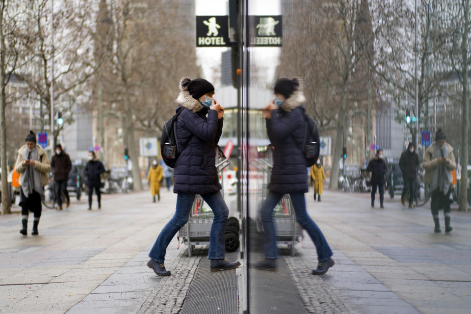 A person wearing a face mask enters a drug store, which is allowed to be open, in Berlin, Thursday, Feb. 4, 2021. Most shops in Germany are still closed to avoid the spreading of the coronavirus, only essential stores are open.(Photo/Markus Schreiber)