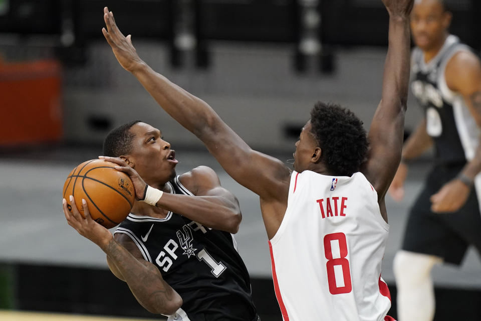 San Antonio Spurs guard Lonnie Walker IV (1) drives to the basket against Houston Rockets forward Jae'Sean Tate (8) during the first half of an NBA basketball game in San Antonio, Thursday, Jan. 14, 2021. (AP Photo/Eric Gay)
