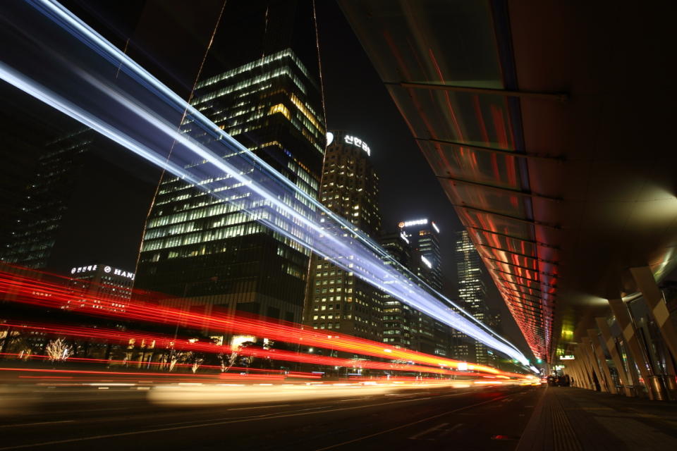 Light trails left by moving traffic run along a road in this long exposure photograph taken in the Yeouido financial district at night in Seoul, South Korea. (Photo: Bloomberg)