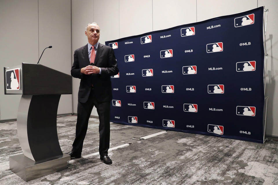 Baseball commissioner Rob Manfred steps away from the podium after speaking to the media at the owners meeting in Arlington, Texas, Thursday, Nov. 21, 2019. (AP Photo/LM Otero)