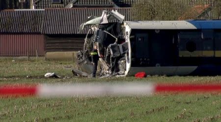 A derailed Dutch passenger train is seen in Dalfsen, Netherlands, in this still image from a video released February 23, 2016. REUTERS/NOS via Reuters TV