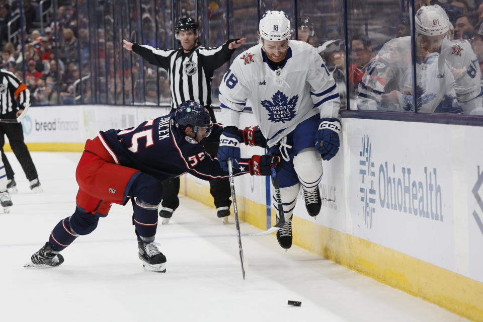 Toronto Maple Leafs' Noah Gregor, right, avoids a check by Columbus Blue Jackets' David Jiricek during the first period of an NHL hockey game Friday, Dec. 29, 2023, in Columbus, Ohio. (AP Photo/Jay LaPrete)