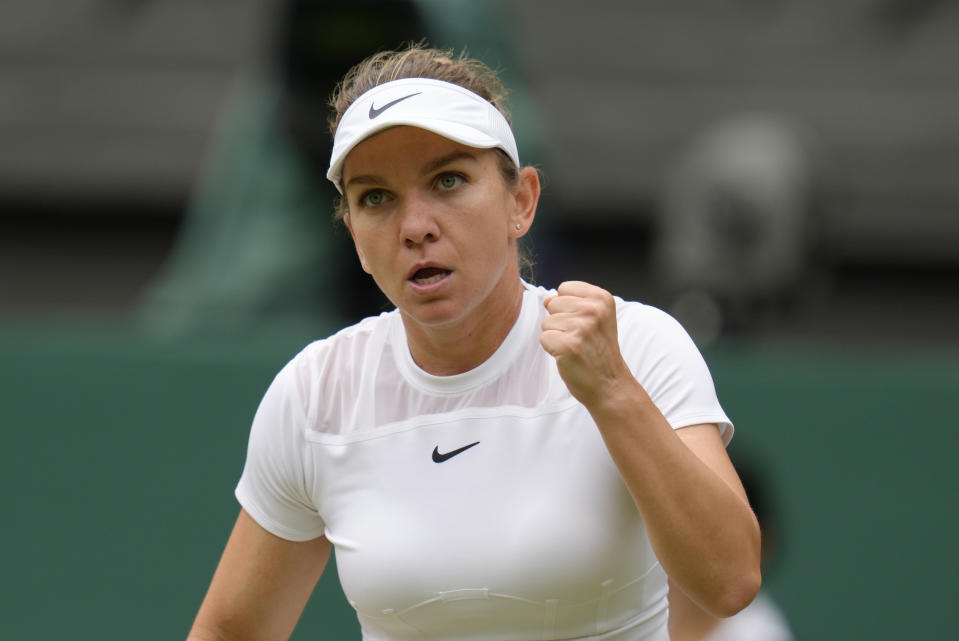 Romania's Simona Halep reacts after winning the first set against Amanda Anisimova of the US in a women's singles quarterfinal match on day ten of the Wimbledon tennis championships in London, Wednesday, July 6, 2022. (AP Photo/Kirsty Wigglesworth)