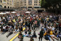 South Africa fans watching a giant screen at the Nelson Mandela Square in Johannesburg, South Africa, celebrate South Africa scoring points during the Rugby World Cup final between South Africa and England being played in Tokyo, Japan on Saturday Nov. 2, 2019. South Africa defeated England 32-12. (AP Photo/Denis Farrell)