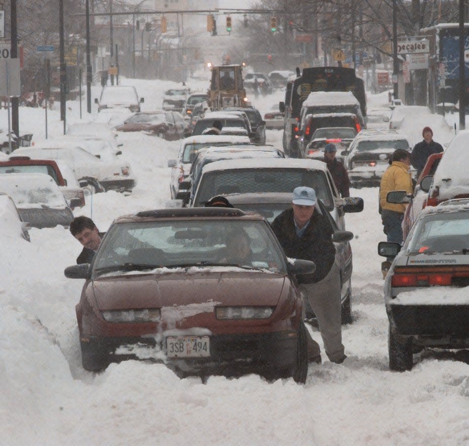 Cars trying to navigate snow-clogged Monroe Avenue in Rochester on March 4, 1999.