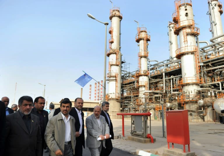 Former Iranian President Mahmoud Ahmadinejad (centre of front line) tours the Abadan oil refinery on May 24, 2011