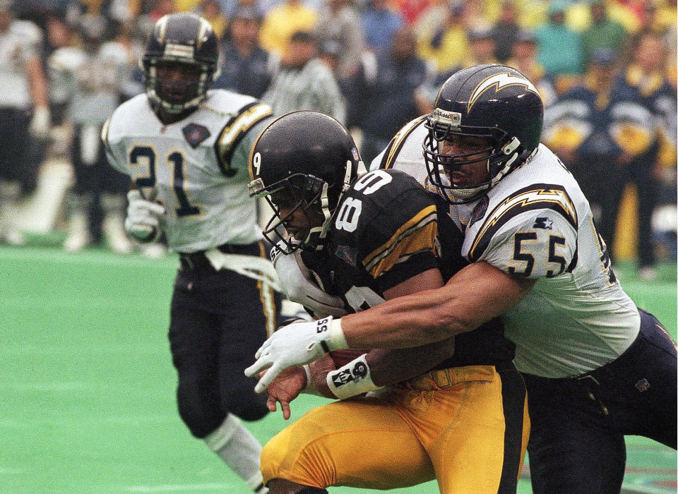 Hall of Fame linebacker Junior Seau, right, was found to have CTE after his death in 2012. Researchers have found strong evidence that repetitive hits to the head, not just concussion, lead to CTE. (AP)