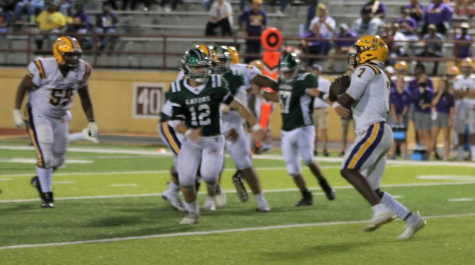 Lutcher quarterback D'wayne Winfield (7) throws as South Terrebonne's Jackson Martin (12) applies pressure during a Sept. 30 game in Houma.