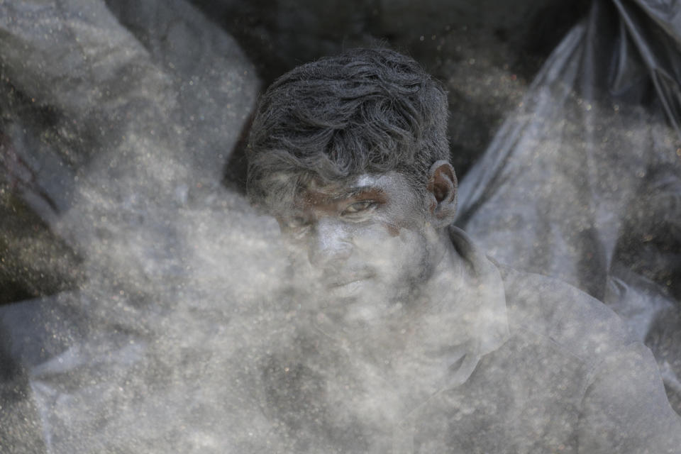 In this Tuesday, Oct. 15, 2019, file photo, an Indian worker mixes gun powder to make firecrackers for the upcoming Hindu festival Diwali at a factory on the outskirts of Ahmadabad, India. Fire crackers are in huge demand in India during Diwali, the festival of lights. (AP Photo/Ajit Solanki, File)