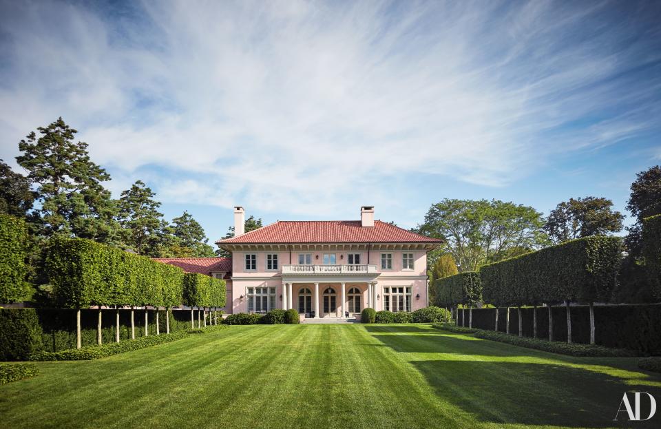 The house’s stucco exterior and tile roof allude to an earlier home on the property.