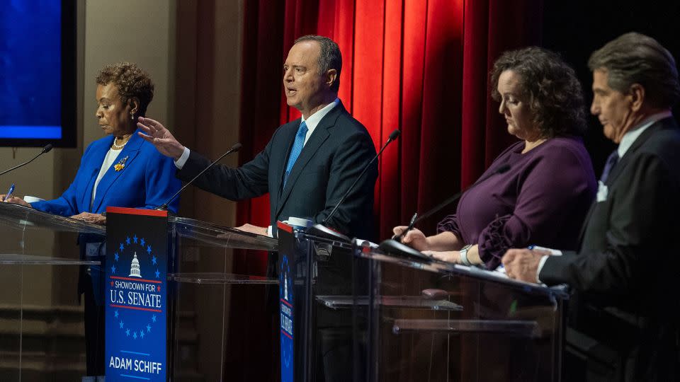Rep. Adam Schiff, second from left, speaks as Reps. Barbara Lee and Katie Porter and former baseball player Steve Garvey listen on stage during a televised debate on January 22 in Los Angeles. - Damian Dovarganes/AP