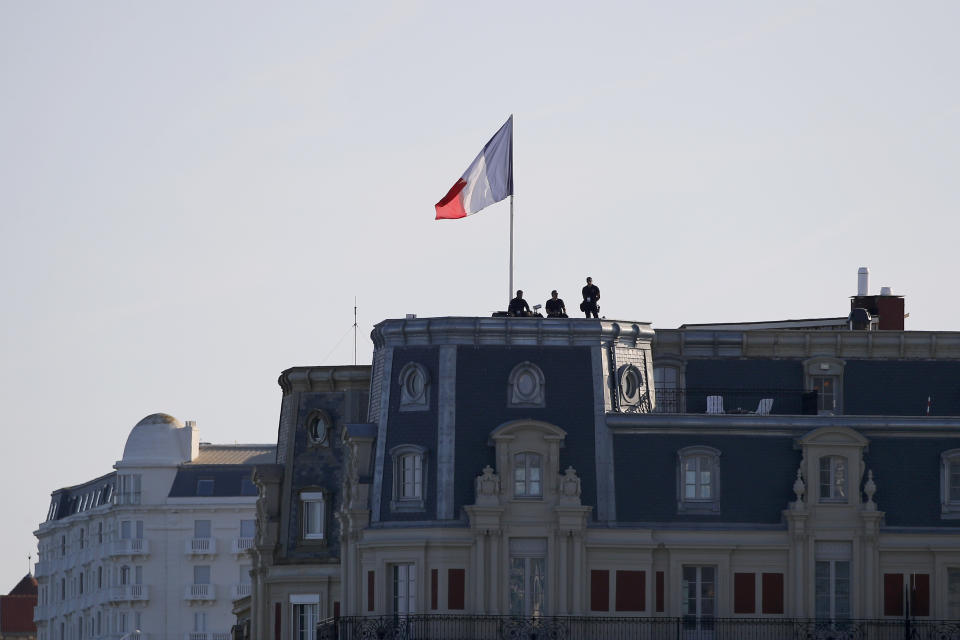 Police forces stand atop a building roof Saturday, Aug. 24, 2019 in Biarritz. Leaders of the Group of Seven countries arrive on Saturday to discuss issues including the struggling global economy and climate change until Monday. They include the United States, Germany, Japan, Britain, France, Canada and Italy. (AP Photo/Francois Mori)