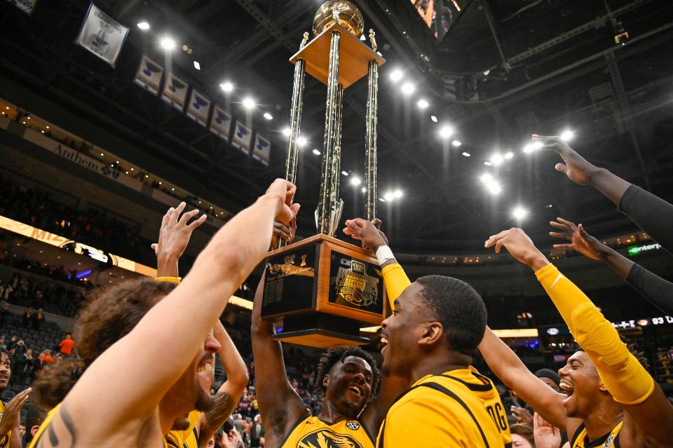 Missouri Tigers celebrate with the Braggin Rights Trophy on Dec. 22, 2023, after defeating the Illinois Fighting Illini at Enterprise Center.