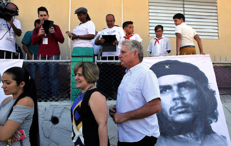 FILE PHOTO: Cuba's First Vice-President Miguel Diaz-Canel and his wife Lis Cuesta stand in line before Diaz-Canel casts his vote during an election of candidates for the national and provincial assemblies, in Santa Clara, Cuba, March 11, 2018. REUTERS/Alejandro Ernesto/Pool/File Photo