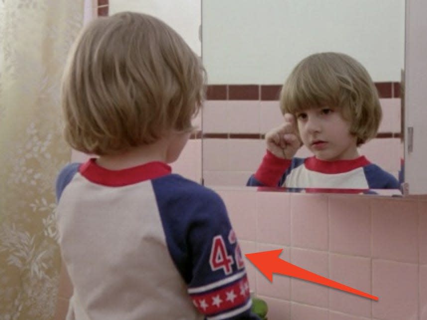 the son in "The Shining" is wearing a t shirt with the number 42 on the sleeve and staring in the bathroom mirror