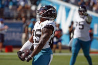 Jacksonville Jaguars running back James Robinson, left, celebrates his 4-yard touchdown run against the Arizona Cardinals during the second half of an NFL football game, Sunday, Sept. 26, 2021, in Jacksonville, Fla. (AP Photo/Stephen B. Morton)