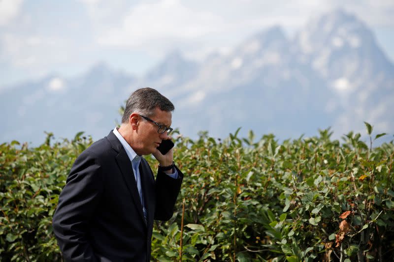 Federal Reserve Vice Chair Richard Clarida talks on the phone during the three-day "Challenges for Monetary Policy" conference in Jackson Hole