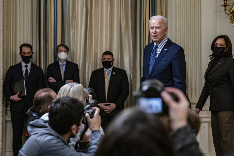 WASHINGTON, DC - MARCH 06: President Joe Biden stops to answer questions from reporters after speaking in the State Dining Room with Vice President Kamala Harris behind him following the passage of the American Rescue Plan in the U.S. Senate at the White House on March 6, 2021 in Washington, DC. The Senate passed the latest COVID-19 relief bill by 50 to 49 on a party-line vote, after an all-night session. (Photo by Samuel Corum/Getty Images)