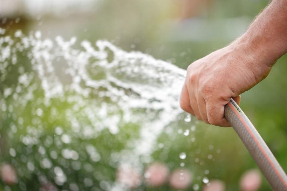 holding water rubber hose tube watering