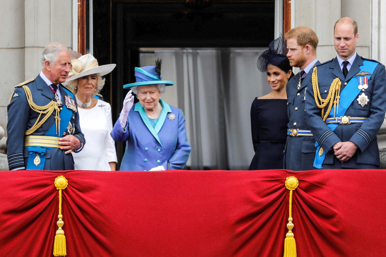 Image: Prince Charles, Prince of Wales, Camilla, Duchess of Cornwall, Queen Elizabeth II, Meghan, Duchess of Sussex, Prince Harry, Duke of Sussex and Prince William, Duke of Cambridge stand on the balcony of Buckingham Palace to watch a military fly-past to mark the centenary of the Royal Air Force (RAF) on July 10, 2018. (Tolga Akmen / AFP - Getty Images file)
